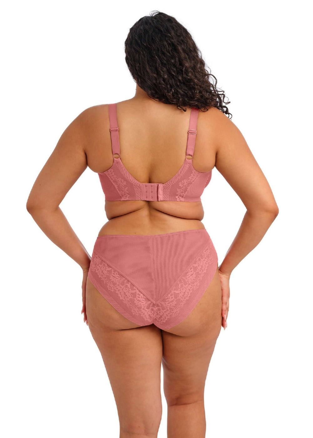 Person wearing a pink bra and high-waisted underwear set on a white background