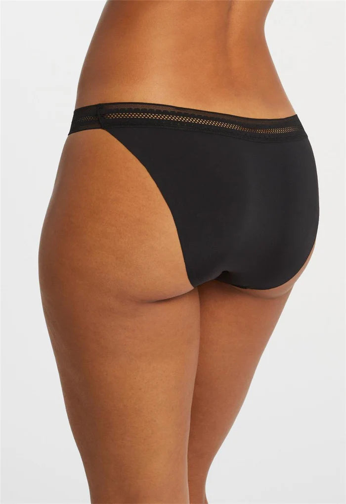 Black underwear worn by a person on a white background