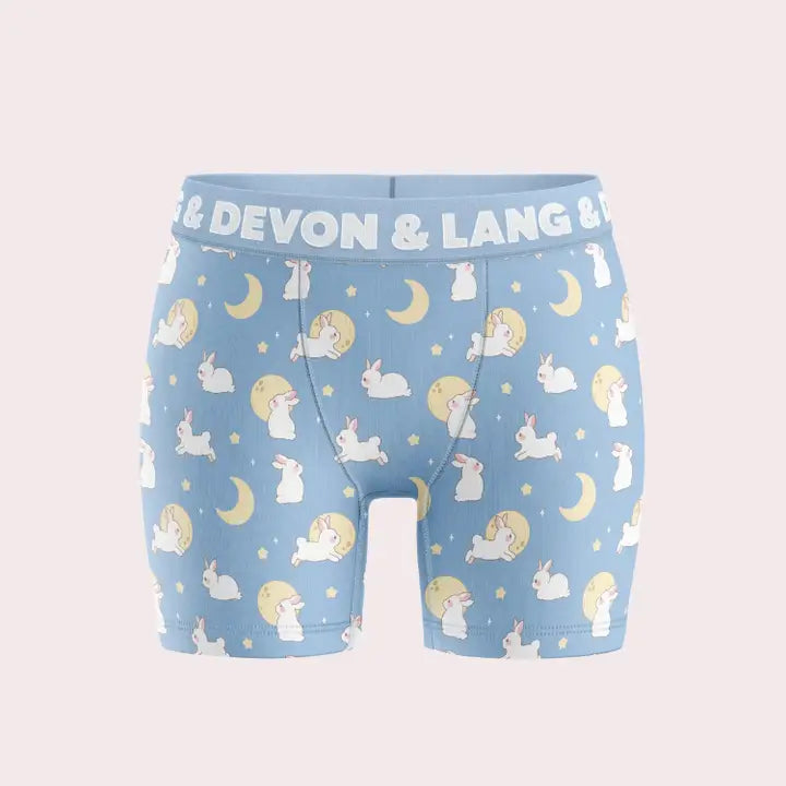 Children's underwear with animal pattern and 'Devon & Lang' branding on a light blue background