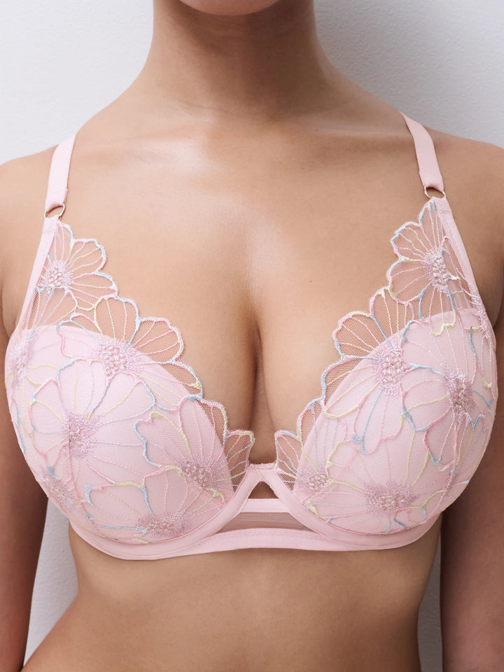 Pink floral lace bra on a neutral background