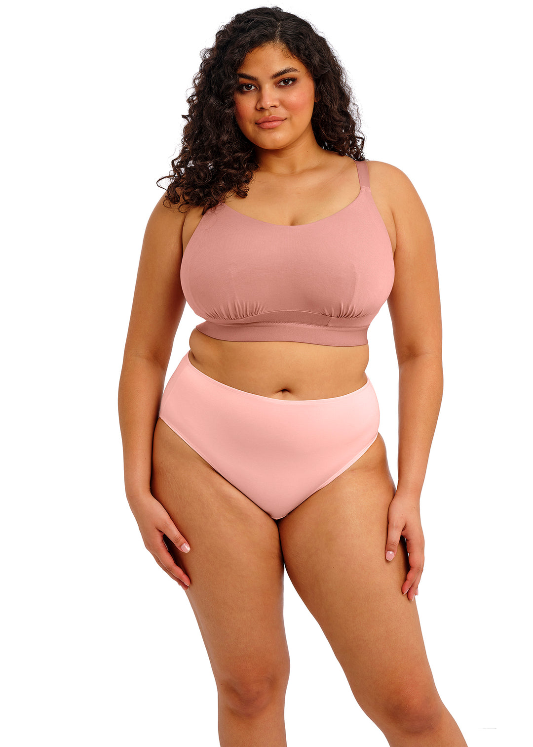 Woman wearing a pink bikini set on a white background