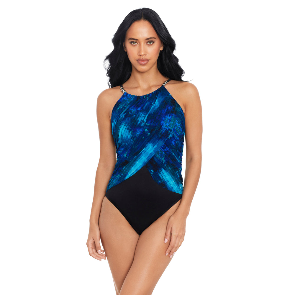 A woman modeling a one-piece swimsuit with a blue and black abstract pattern, set against a plain white background.