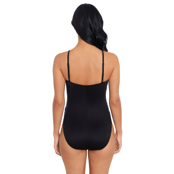 Rear view of a woman modeling a black shapewear bodysuit with thin shoulder straps against a plain white background.