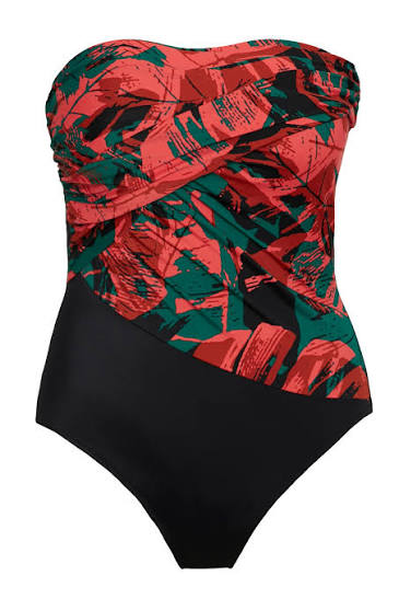 A strapless one-piece swimsuit with a bold abstract print on the bust and upper torso in red, green, and black, combined with a solid black lower body, shown against a plain white background.