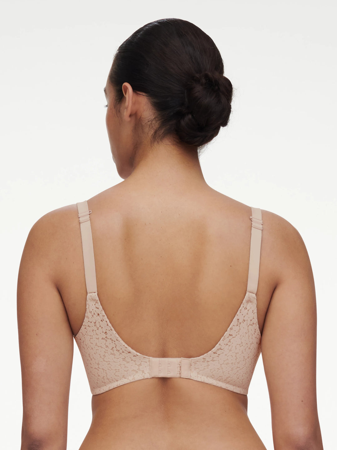 Woman wearing a beige bra on a white background
