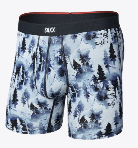 Men's boxer briefs by SAXX featuring a blue and white watercolor pine forest pattern, with a black elastic waistband and a red inner lining.