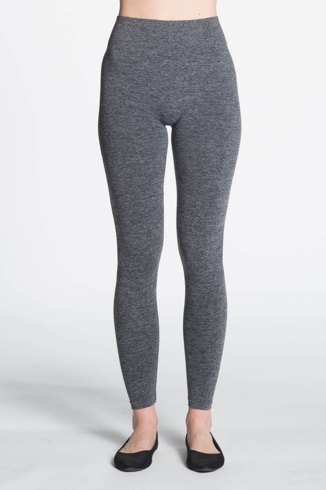 Gray leggings worn by a person on a white background