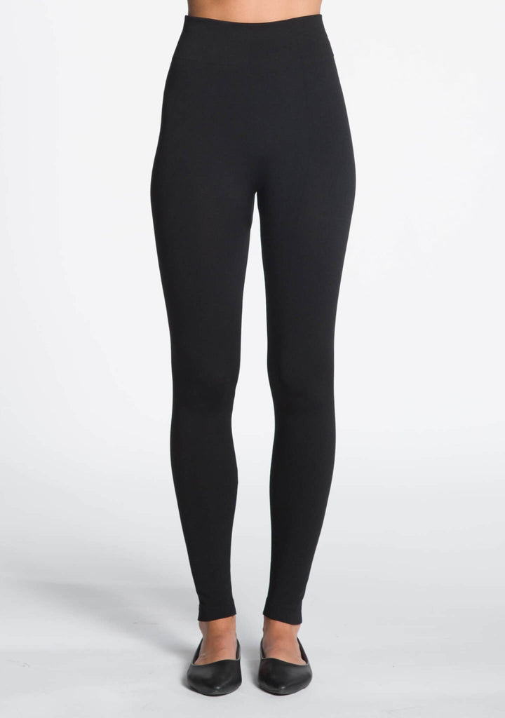 Black leggings worn by a person on a white background